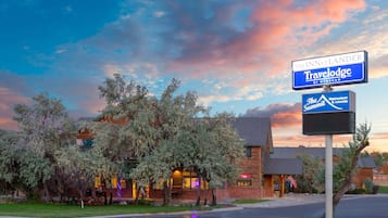 Experience a serene atmosphere at The Inn, surrounded by mature trees and a well-maintained lawn.