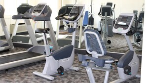 A gym with various exercise machines including treadmills and elliptical trainers. - Inn at Lander, Travelodge by Wyndham (Lander)