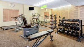 A gym with cardio machines, dumbbells, and a clock on the wall. - La Quinta Inn & Suites by Wyndham Salt Lake City Airport (Salt Lake City)