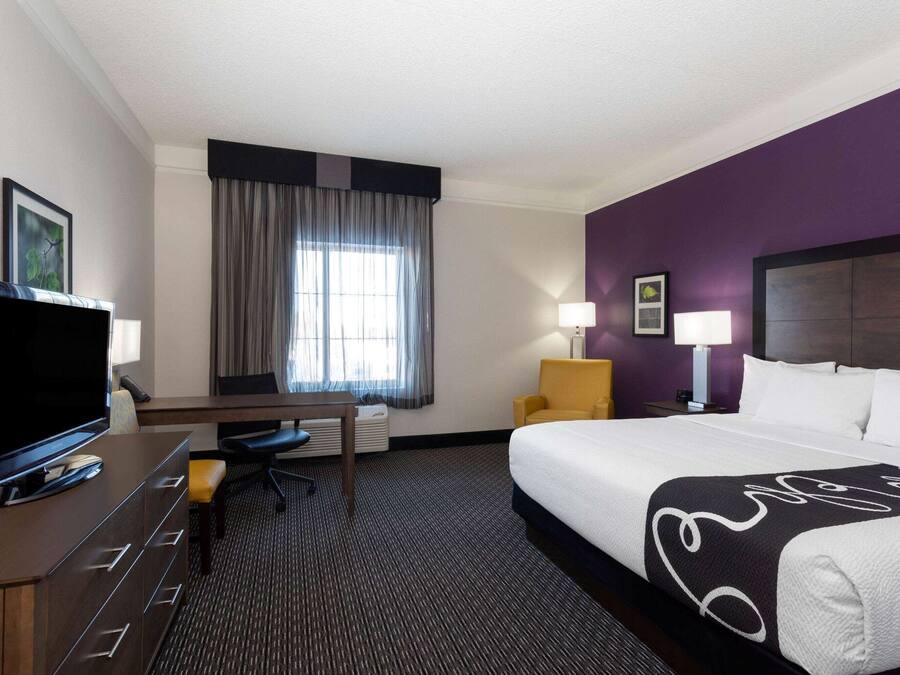 Premium bedding, desk, laptop workspace, blackout curtains