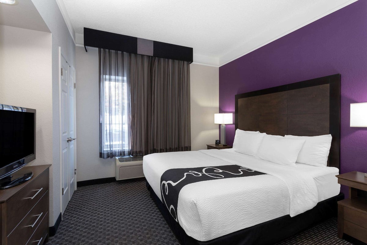 Premium bedding, desk, laptop workspace, blackout drapes