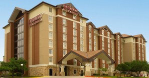 A multi-story hotel with a brown and beige facade, multiple windows, and a covered entrance area. - Drury Inn & Suites San Antonio Northwest Medical Center (San Antonio)