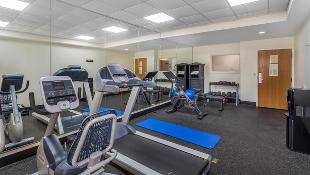 A gym with treadmills, elliptical machines, and free weights. - Best Western Plus Madison (Madison)