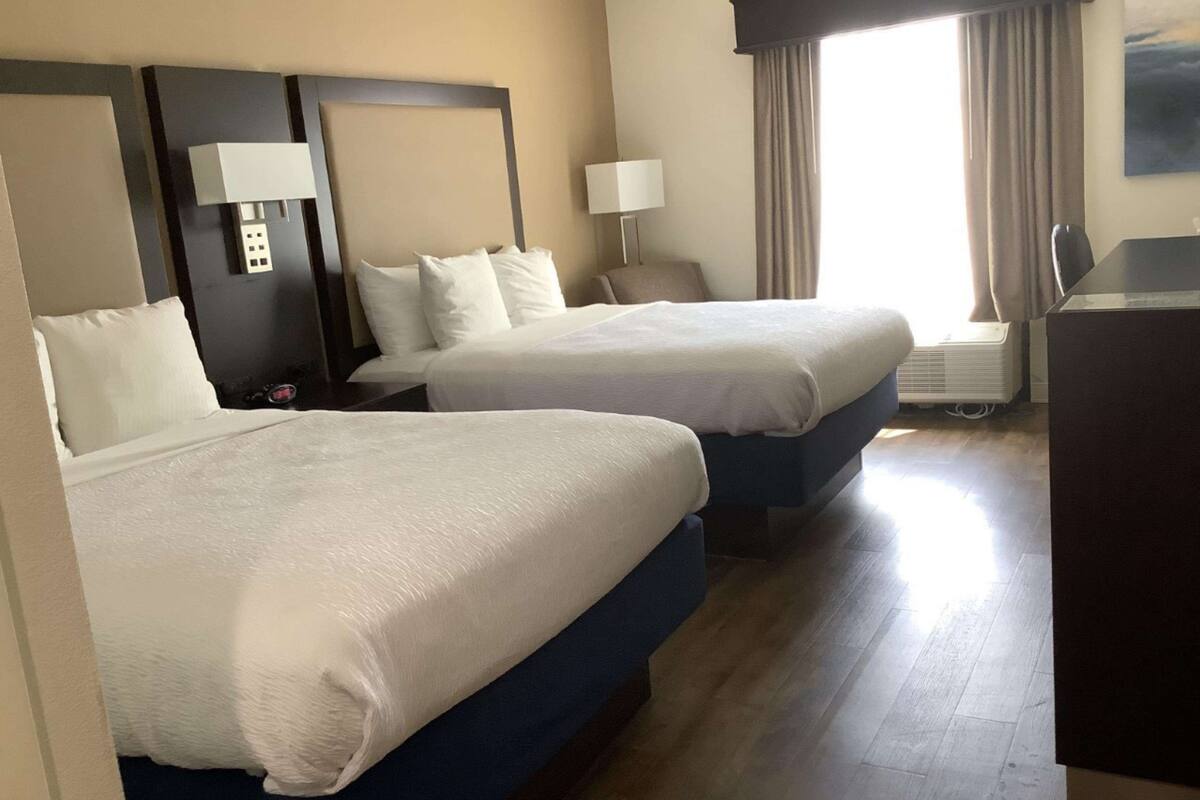 standard room, 2 queen beds, non smoking, refrigerator & microwave | in-room safe, desk, laptop workspace, iron/ironing board