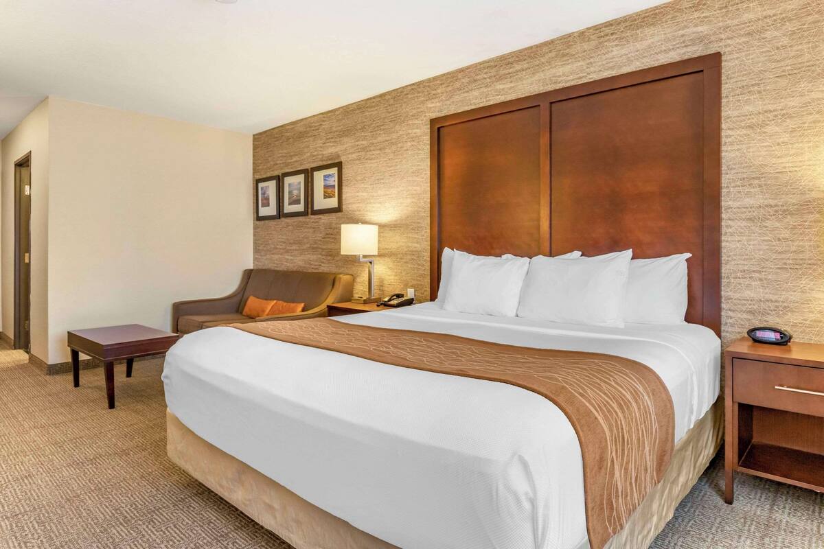 Premium bedding, desk, laptop workspace, iron/ironing board