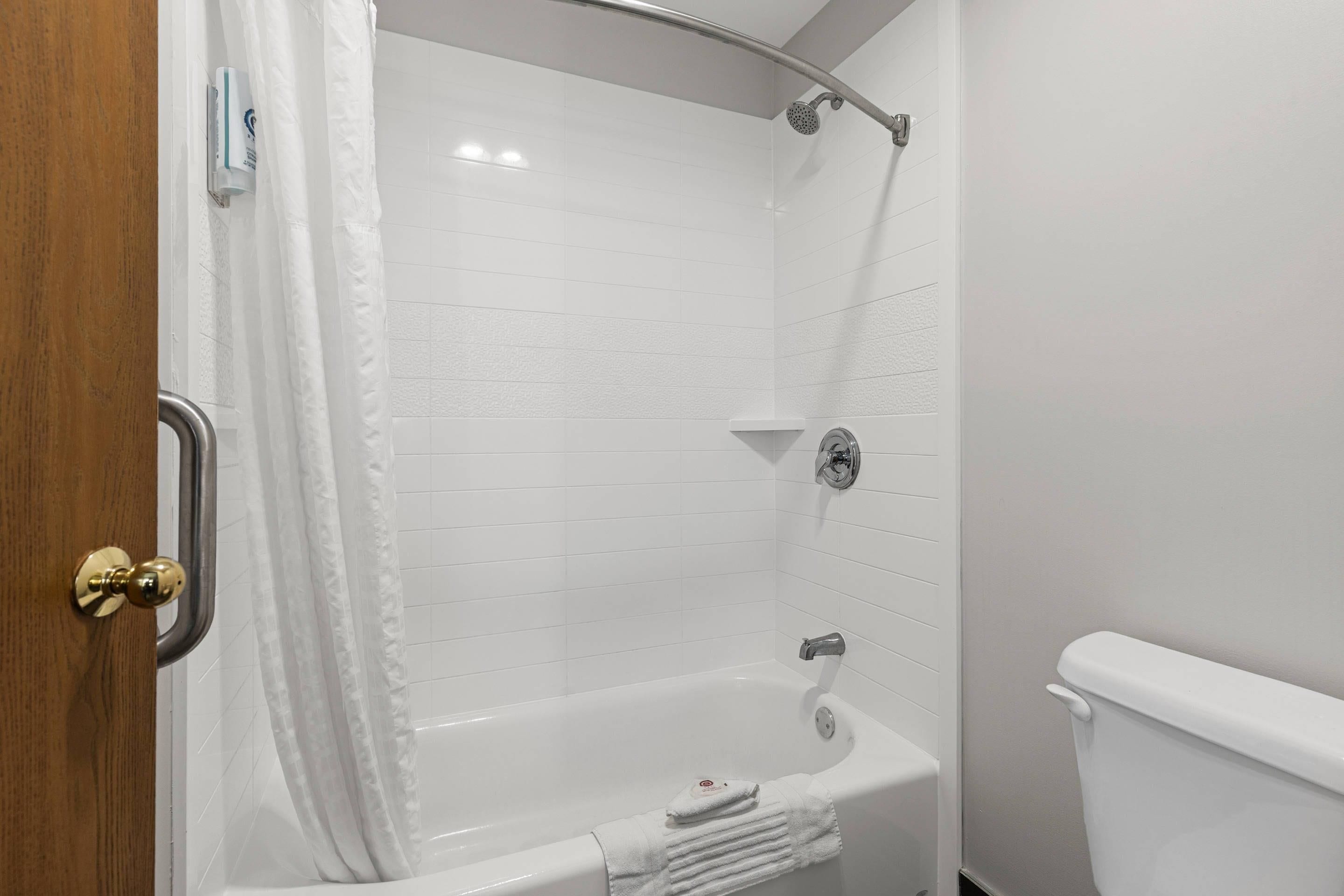 A bathroom with a bathtub, a shower, and a toilet.