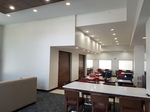 Conference room with a long table and comfortable seating area.