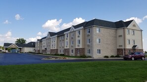 Stylish hotel building with a symmetrical facade, featuring multiple windows and a flat roof.