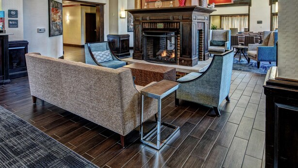 A spacious lobby with a fireplace, comfortable seating, and a modern design.