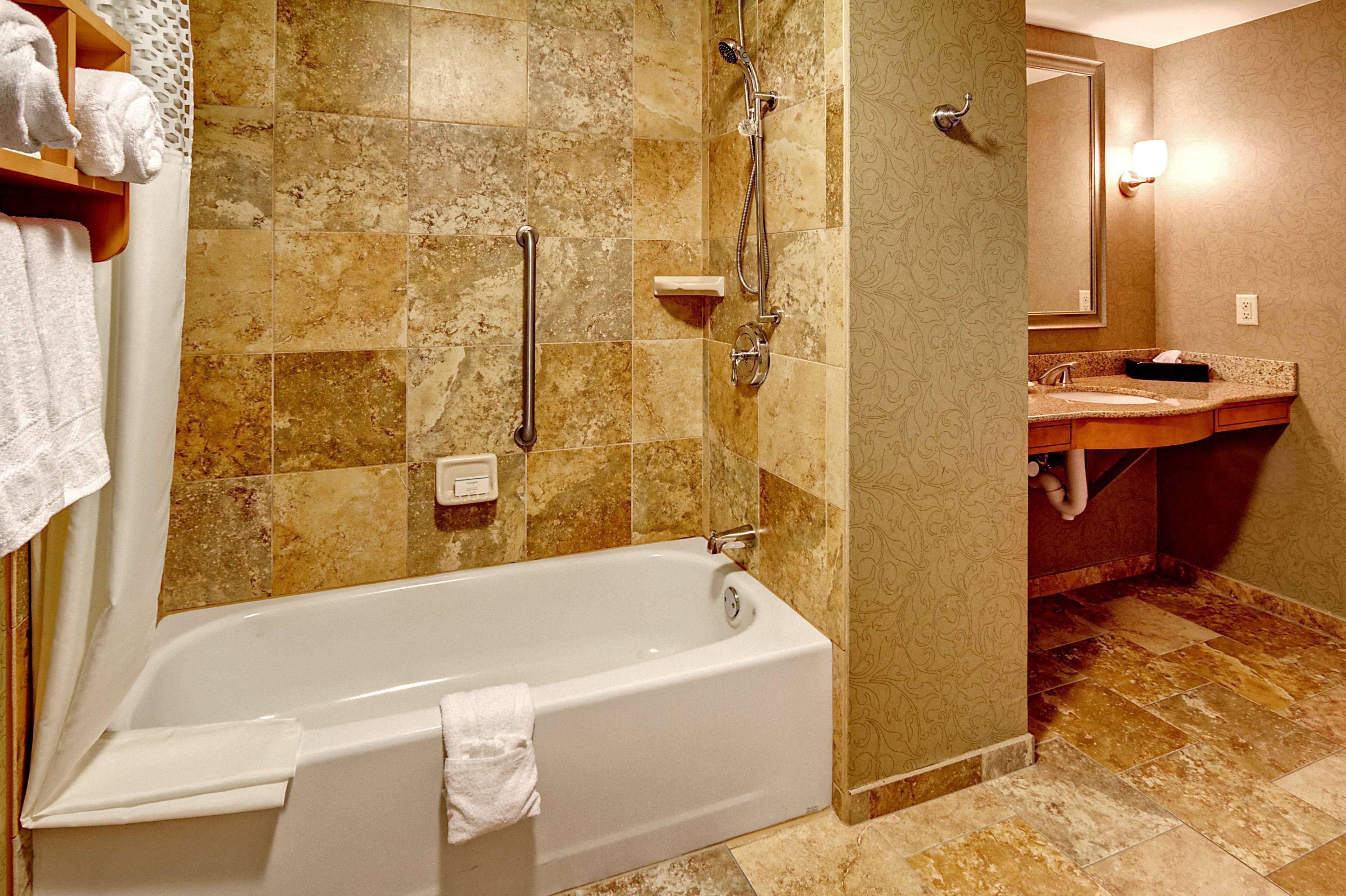 ada accessible suite, 1 king bed, accessible, bathtub | bathroom | combined shower/bathtub, free toiletries, hair dryer, towels