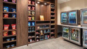 A snack and beverage display area with various brands of chips and drinks.