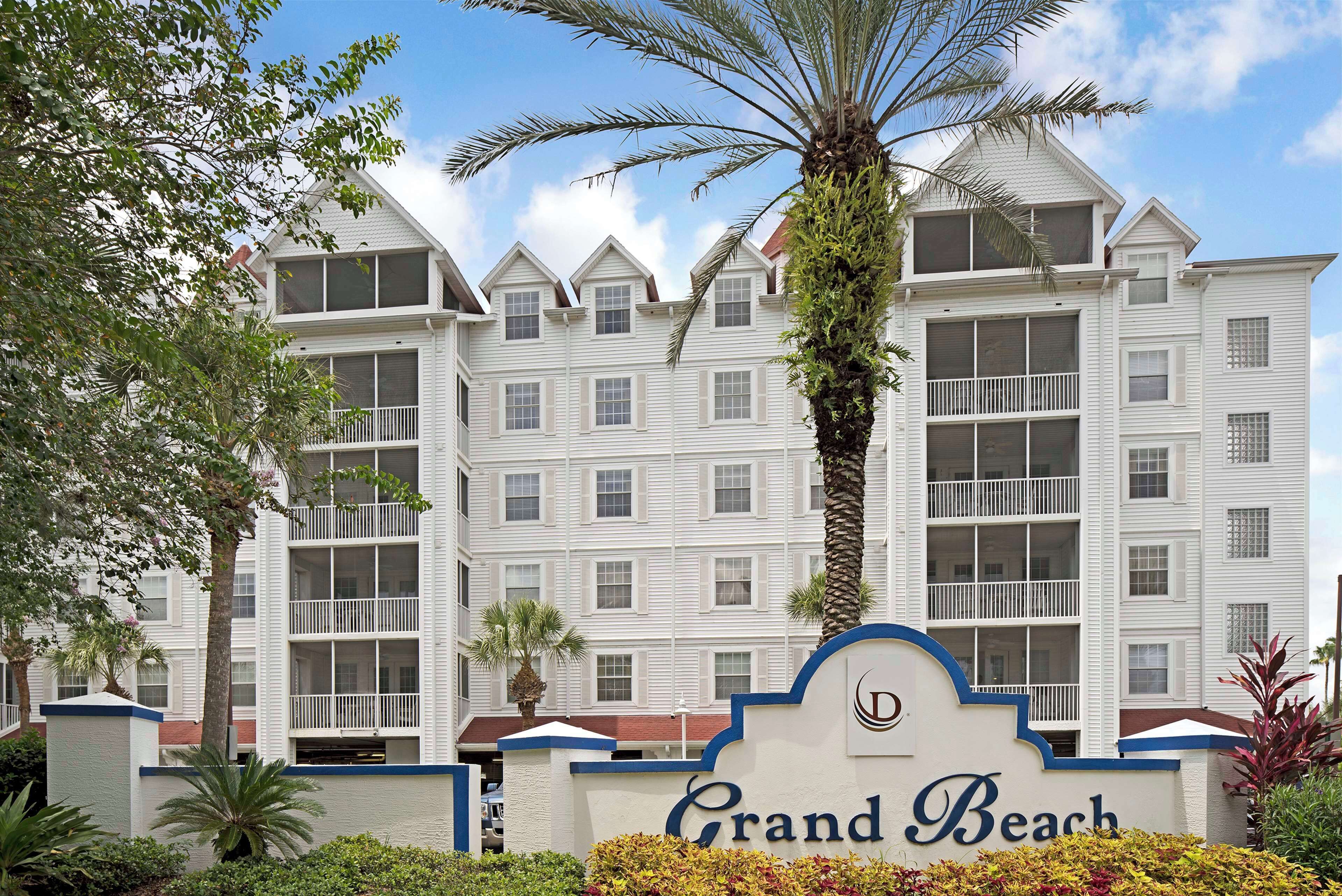 A multi-story hotel with a prominent sign reading "Grand Beach."