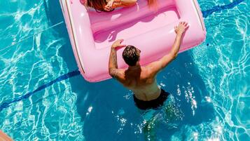 Guests can enjoy a refreshing swim in the pool, surrounded by a blue line.