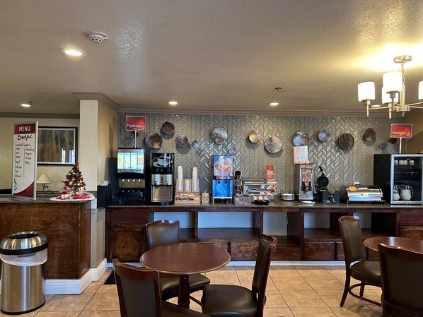 Enjoy a hearty breakfast in our breakfast area, where a variety of options are listed on the wall-mounted menu board and freshly brewed coffee is always available.