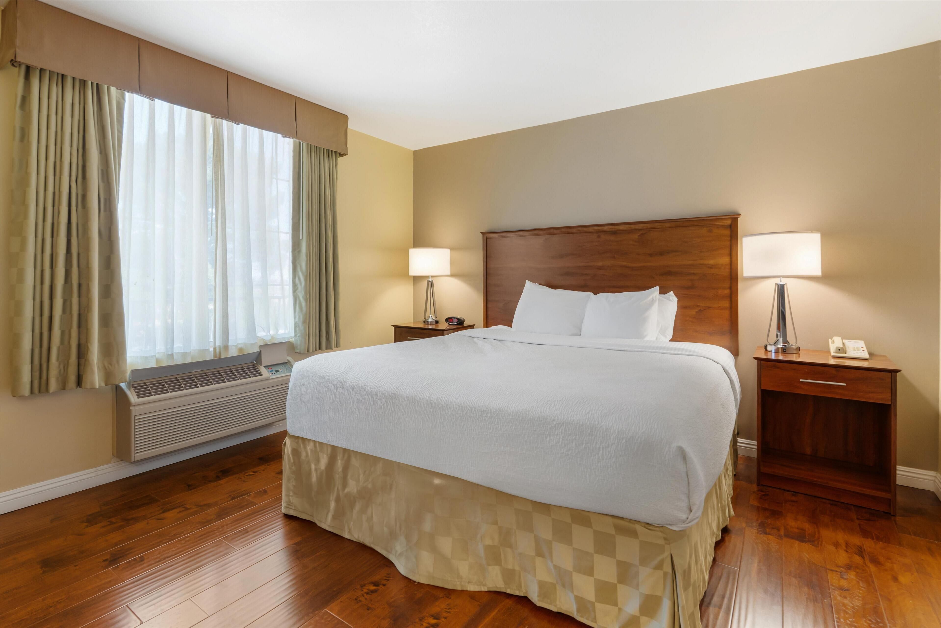 suite, 1 king bed, non smoking, refrigerator & microwave | 1 bedroom, in-room safe, blackout curtains, iron/ironing board