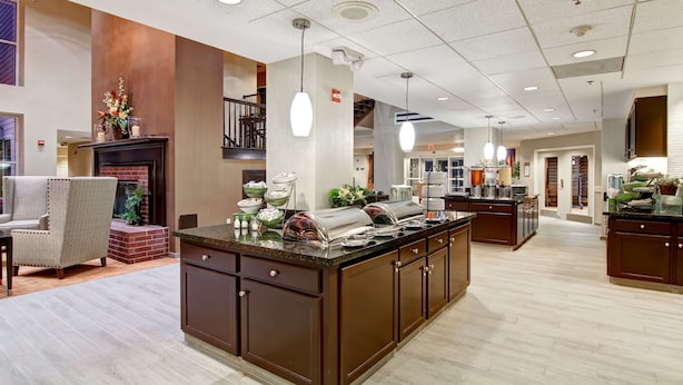 A spacious kitchen with a central island, built-in appliances, and a seating area with a fireplace. - Homewood Suites by Hilton Houston-Kingwood Parc-Airport Area (Kingwood)