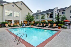 A swimming pool with a metal ladder, surrounded by lounge chairs and potted plants. - Homewood Suites by Hilton Houston-Kingwood Parc-Airport Area (Kingwood)