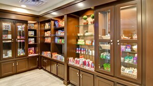 A well-lit, wooden-paneled retail area with glass display cases containing various products. - Homewood Suites by Hilton Houston-Kingwood Parc-Airport Area (Kingwood)
