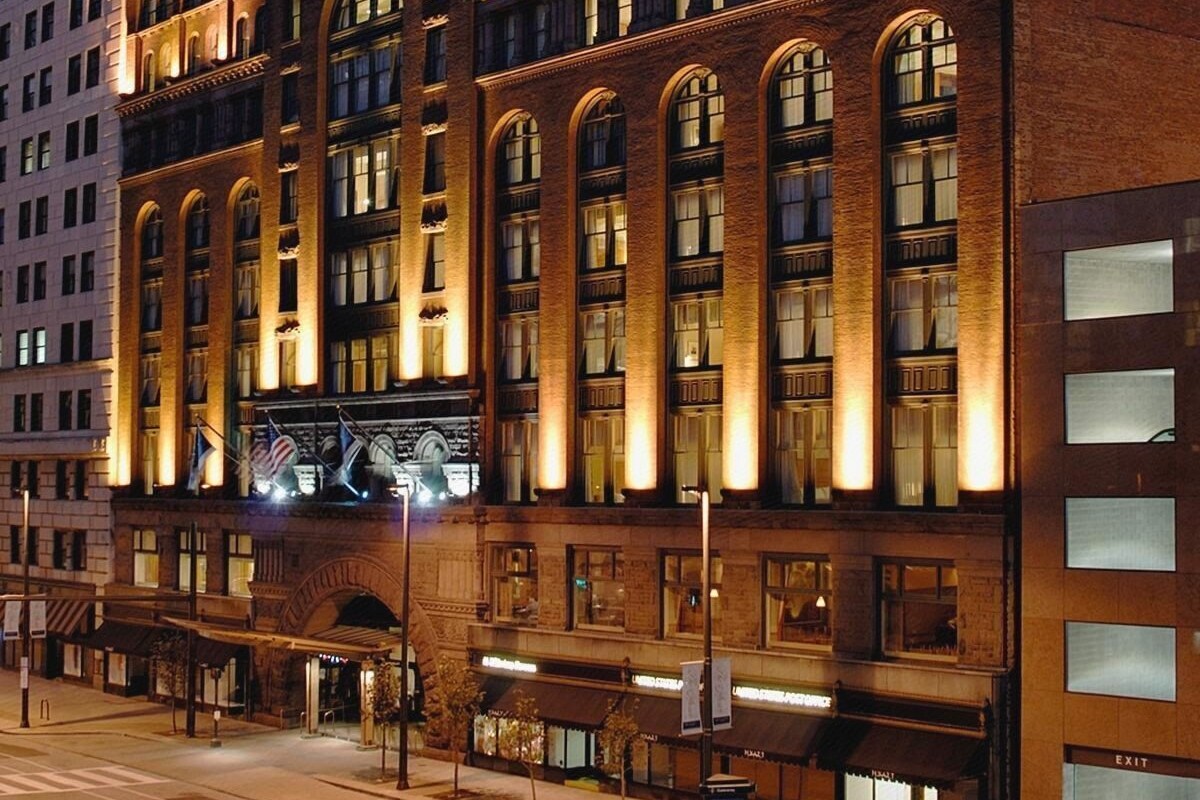 A multi-story hotel with arched windows and a brick facade.