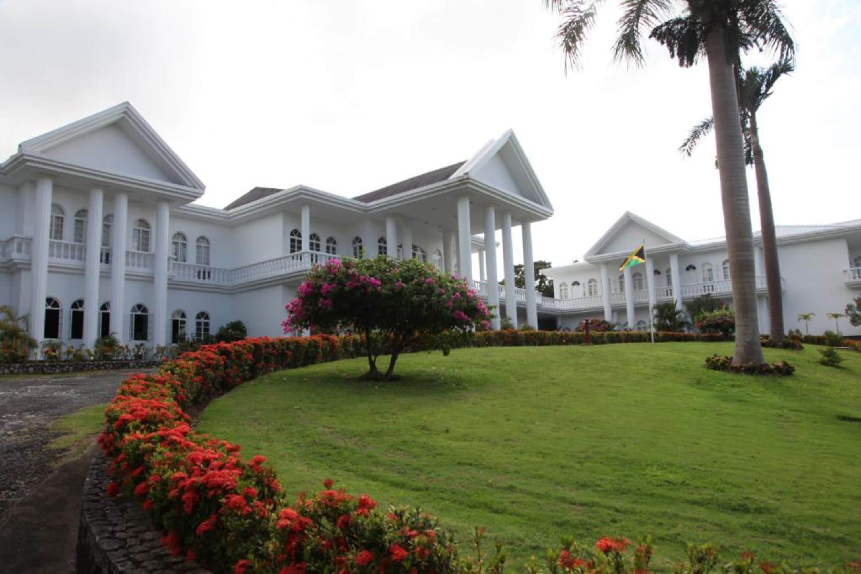 A large white building with multiple columns and a central courtyard.