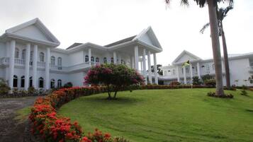 A large white building with multiple columns and a central courtyard.