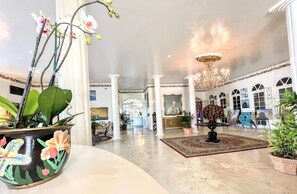 Experience the grandeur of our lobby, featuring a high ceiling, classical architectural elements, and beautiful artwork.