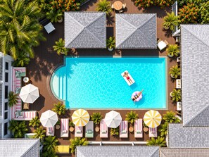 A rooftop pool with a clear blue water surface, surrounded by lounge chairs and umbrellas. - Hotel La Plantation (Orient Bay)