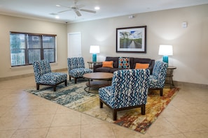 Relax in this inviting living room with a sofa set, armchairs, and a coffee table.