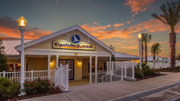 A building with a sign reading "Registration & Activities" and a number "100" on the facade. - Holiday Inn Club Vacations Orlando Breeze Resort by IHG (Davenport)