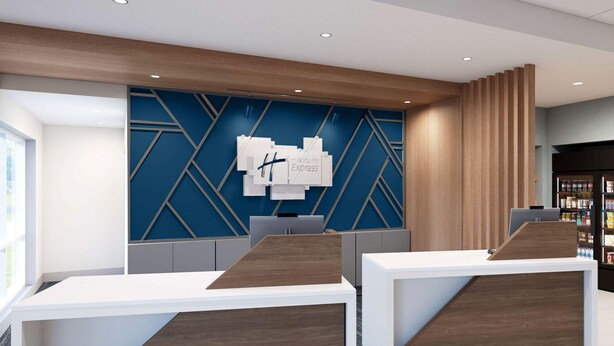 Un área de recepción de diseño moderno, con una pared azul geométrica y mostradores de recepción de madera.