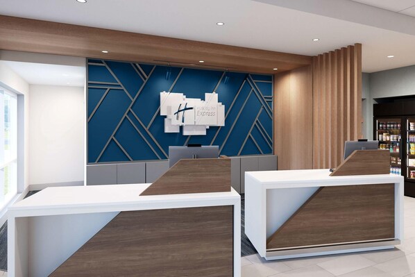 Un área de recepción de diseño moderno, con una pared azul geométrica y mostradores de recepción de madera.