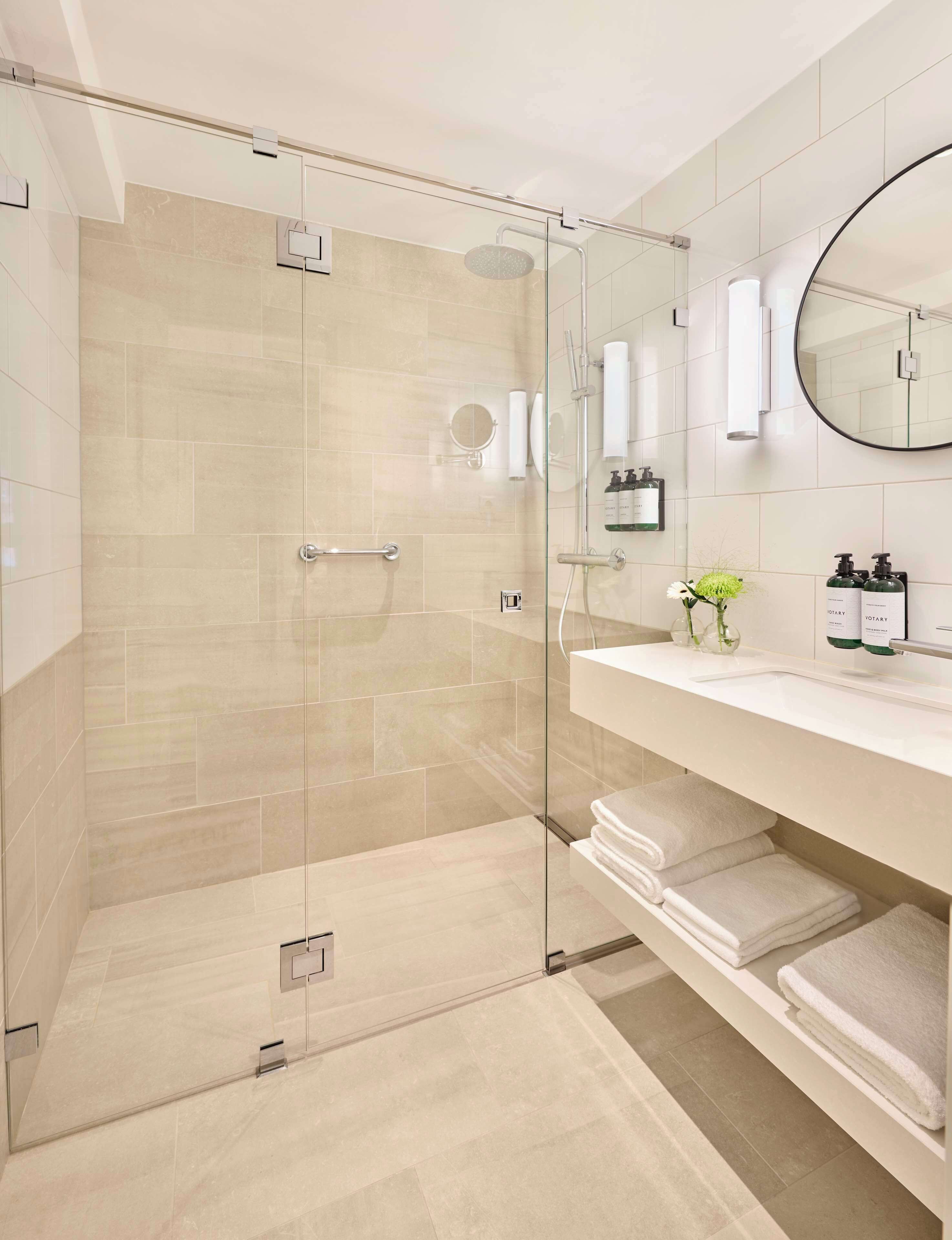 Shower, designer toiletries, hair dryer, bathrobes
