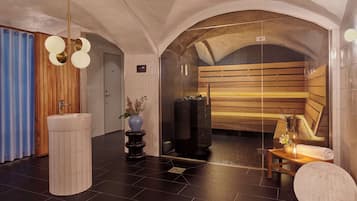 A modern spa area with a wooden bench, a sink, and a glass-enclosed sauna.