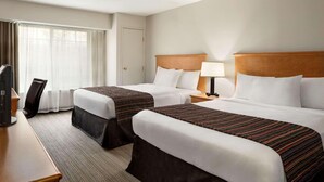 A hotel room with two beds, a desk, a chair, and a television. - Country Inn & Suites by Radisson, Columbus Airport, OH (Columbus)