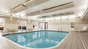 An indoor swimming pool with clear blue water, tiled floor, and ceiling lights. - Country Inn & Suites by Radisson, Columbus Airport, OH (Columbus)