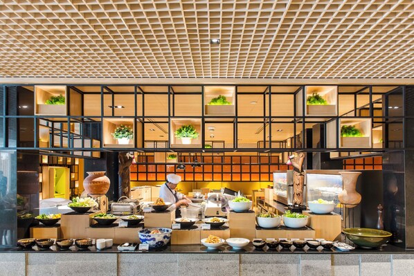 A modern restaurant with a high ceiling and a grid pattern.