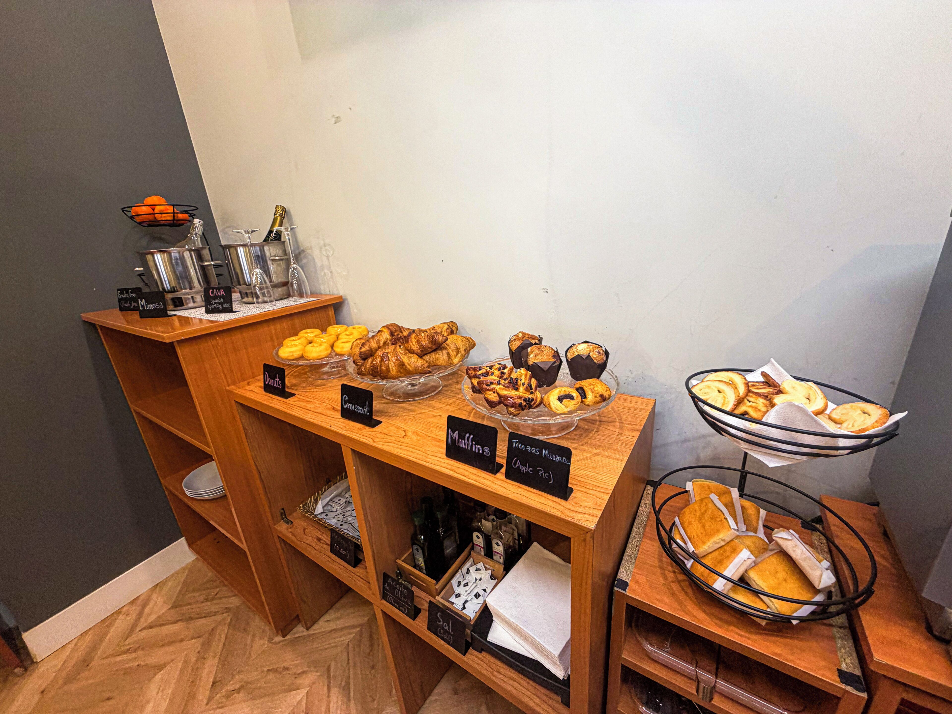 A buffet with various baked goods and a coffee station.