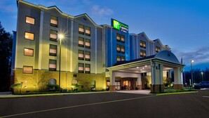 A Holiday Inn Express hotel with a covered entrance and a brick facade.
