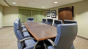 A conference room with a long table and eight chairs.