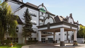 Un hotel Wingate Inn con un diseño arquitectónico moderno, que cuenta con una entrada cubierta y jardines.