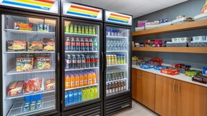 A refrigerated display case with various food items and beverages.