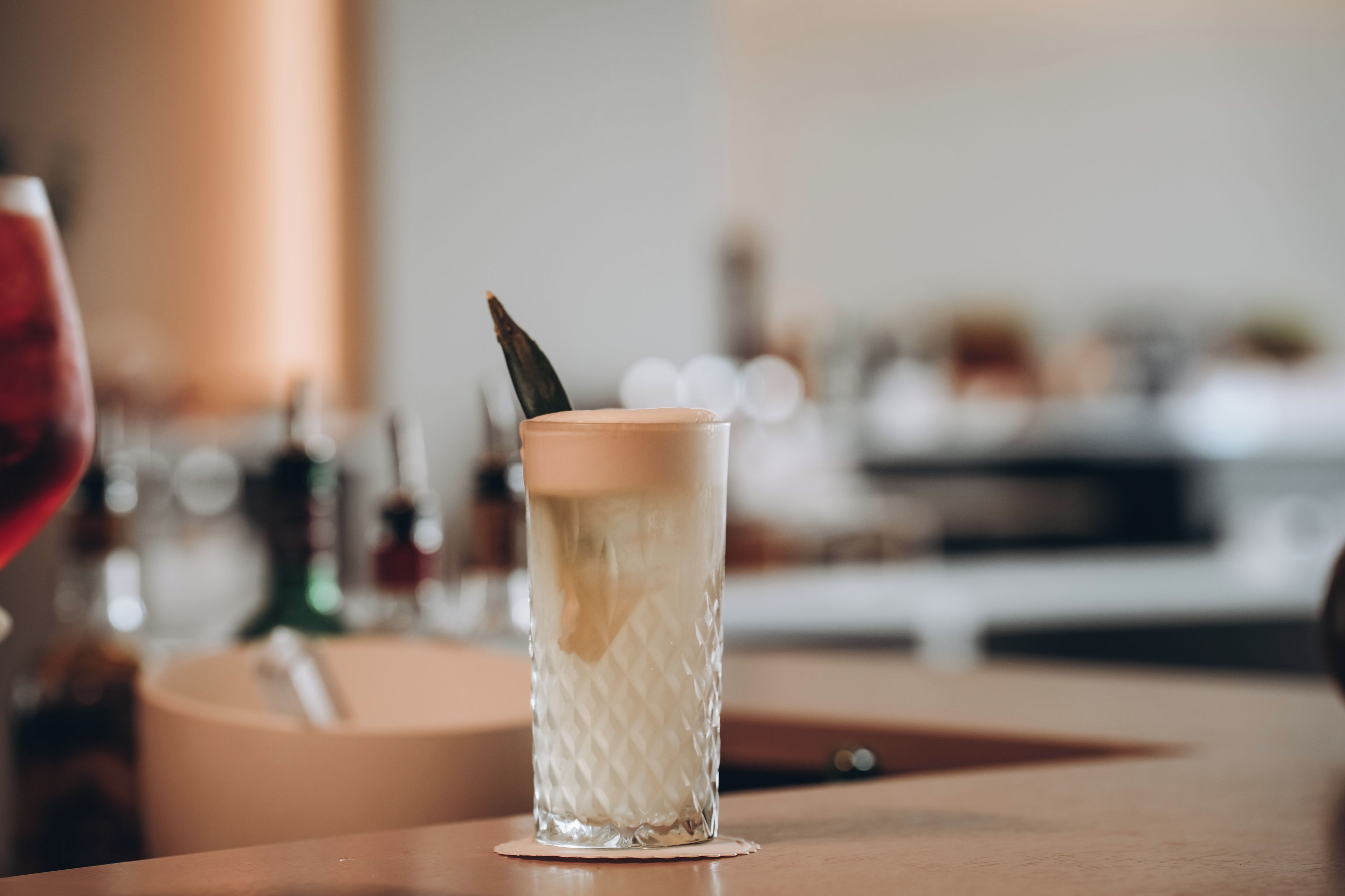A clear glass with a textured pattern, placed on a wooden surface.
