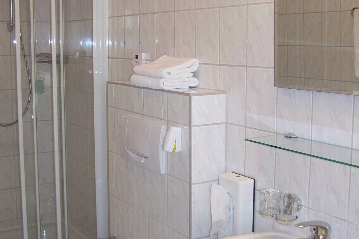 shower, rainfall showerhead, hair dryer, towels