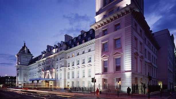 A historic building with classical architecture, large windows, and a prominent corner tower. - Hilton London Paddington (London)