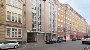 A hotel with a modern facade, multiple windows, and a sign indicating it is a hotel. - Trip Inn Hotel Minerva (Frankfurt)