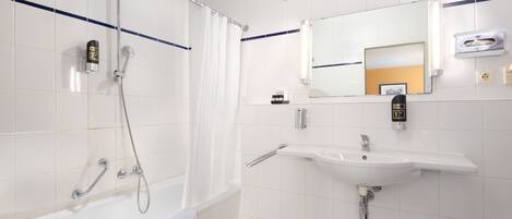 A modern bathroom with a bathtub, shower, and sink.