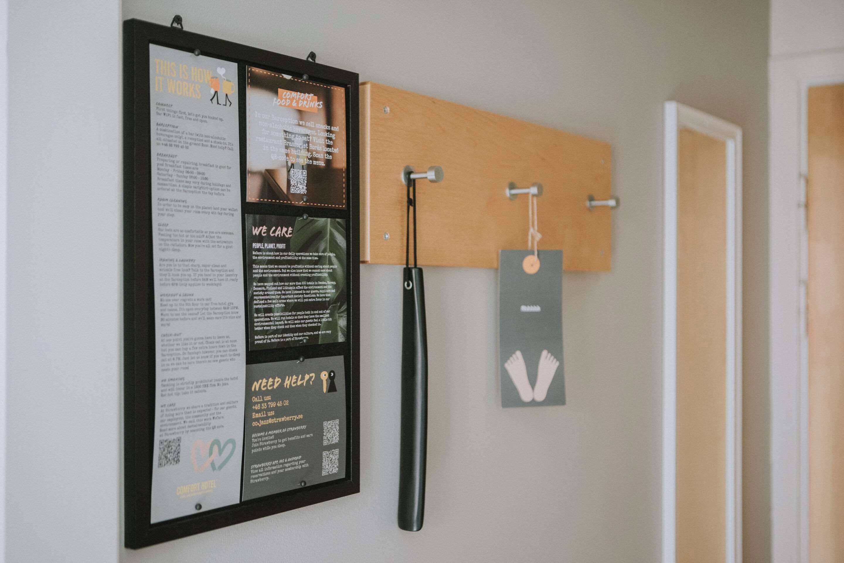 A bulletin board with various notices and a hanging sign.