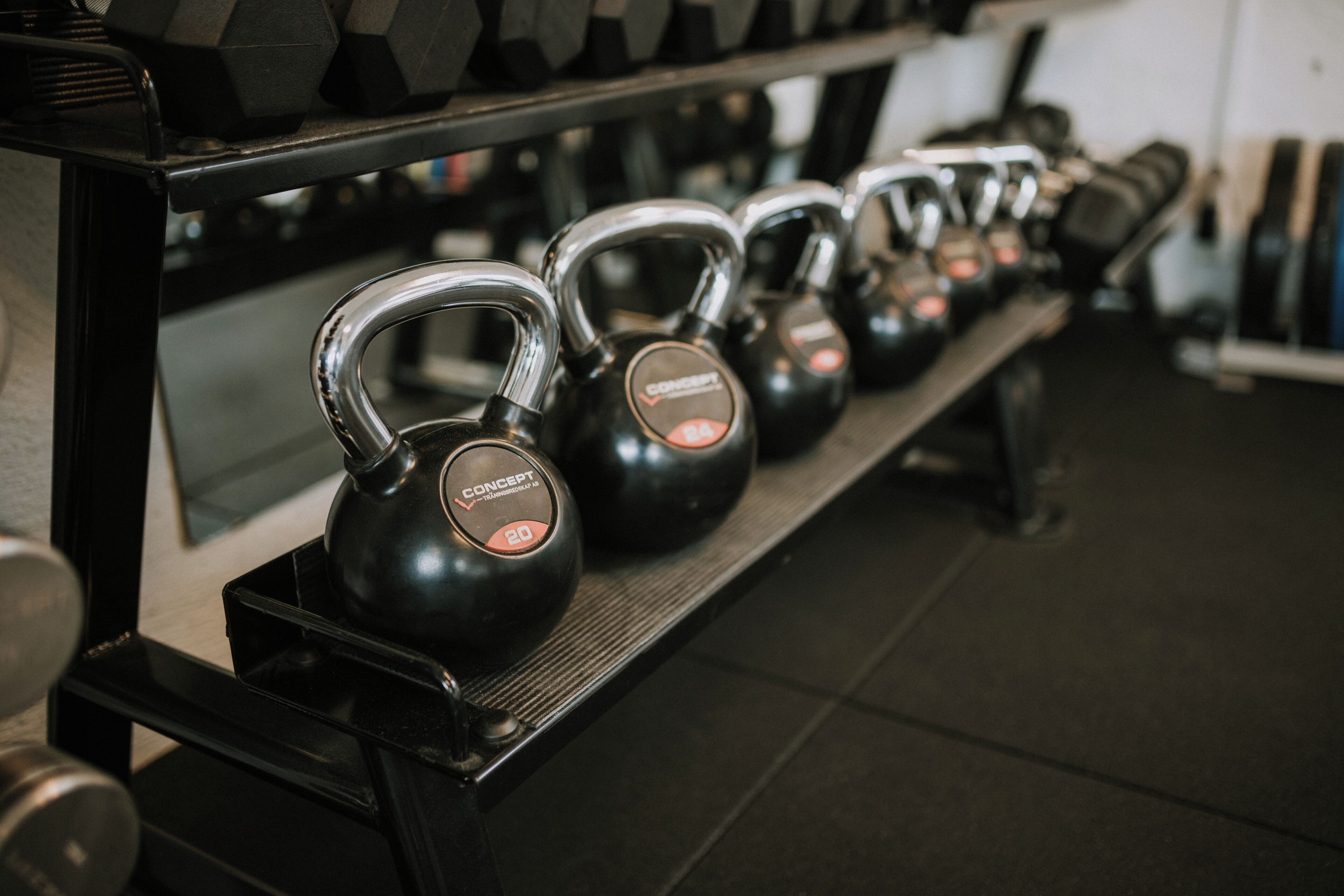 Kettlebells on a rack in a gym.