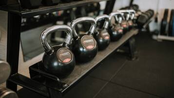 Kettlebells on a rack in a gym.