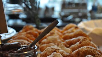 A table with pastries and a jar of chocolate spread.